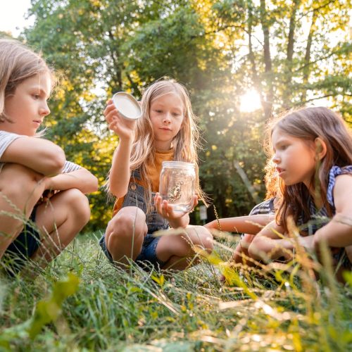 side-view-kids-sitting-grass-min